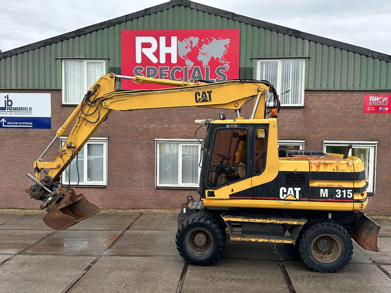 Caterpillar M315 +ROTO CE - Колёсный экскаватор: фото 1 Caterpillar M315 +ROTO CE - Колёсный экскаватор: фото 1